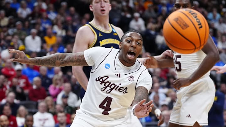 Mar 22, 2025; Denver, CO, USA; Texas A&M Aggies guard Wade Taylor IV (4) attempts to get the ball against the Michigan Wolverines during the second half in the second round of the NCAA Tournament  at Ball Arena. Mandatory Credit: Ron Chenoy-Imagn Images