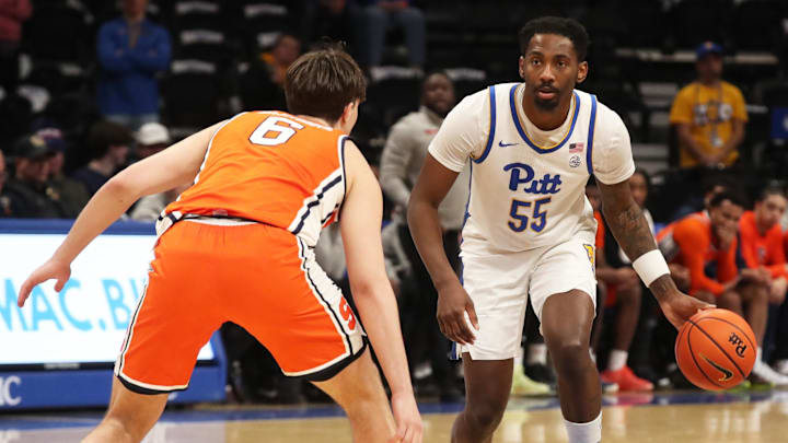 Feb 18, 2025; Pittsburgh, Pennsylvania, USA; Pittsburgh Panthers forward Zack Austin (55) dribbles against Syracuse Orange forward Petar Majstorovic (6) during the second half at the Petersen Events Center. Mandatory Credit: Charles LeClaire-Imagn Images