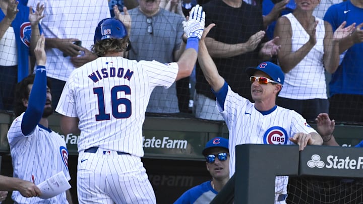 Sep 21, 2024; Chicago, Illinois, USA;  Chicago Cubs first baseman Patrick Wisdom (16) celebrates with manager Craig Counsell after his home run against the Washington Nationals during the seventh inning at Wrigley Field.