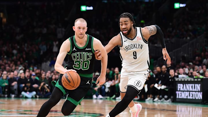 Mar 18, 2025; Boston, Massachusetts, USA; Boston Celtics forward Sam Hauser (30) controls the ball while Brooklyn Nets forward Trendon Watford (9) defends during the second half at TD Garden. Mandatory Credit: Bob DeChiara-Imagn Images