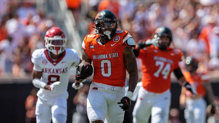 Sep 7, 2024; Stillwater, Oklahoma, USA; Oklahoma State Cowboys running back Ollie Gordon II (0) runs the ball during the fourth quarter against the Arkansas Razorbacks at Boone Pickens Stadium. 