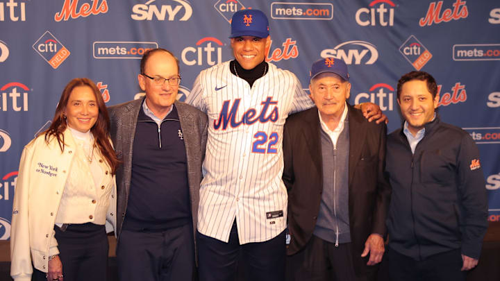 Dec 12, 2024; Flushing, NY, USA; New York Mets right fielder Juan Soto (center) poses for photos with team owner Steve Cohen (second from right) and the Cohen family during a press conference at Citi Field. Mandatory Credit: Brad Penner-Imagn Images