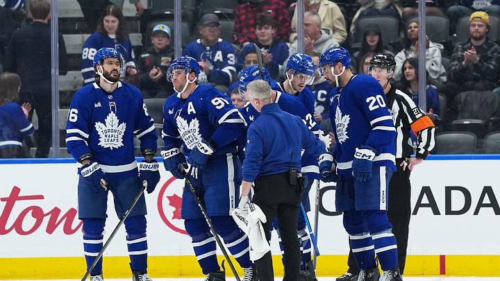 Oct 15, 2026; Toronto, Ontario, CAN;  Toronto Maple Leafs center John Tavares (91) is helped off the ice by defenseman Jake McCabe (22) against the Buffalo Sabres during the third period at Scotiabank Arena.  Mandatory Credit: Nick Turchiaro-Imagn Images