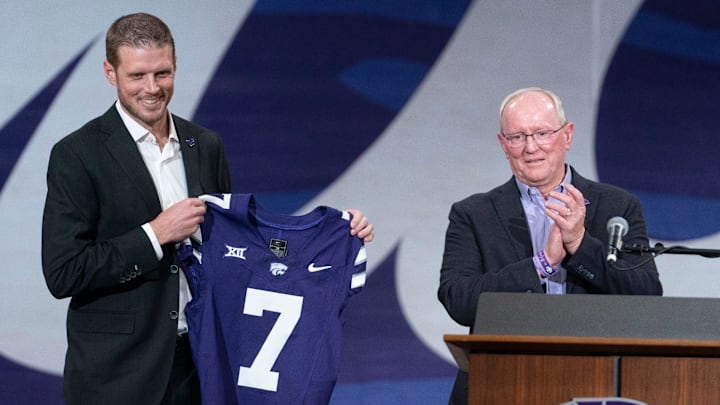 Kansas State new head football coach Collin Klein holds a jersey given by athletic director Gene Taylor during his introduction ceremony at Morgan Family Arena on Dec. 5, 2025.