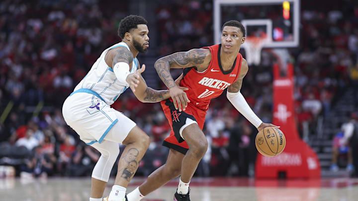 Oct 23, 2024; Houston, Texas, USA; Houston Rockets forward Jabari Smith Jr. (10) dribbles the ball as Charlotte Hornets forward Miles Bridges (0) defends during the first quarter at Toyota Center. Mandatory Credit: Troy Taormina-Imagn Images