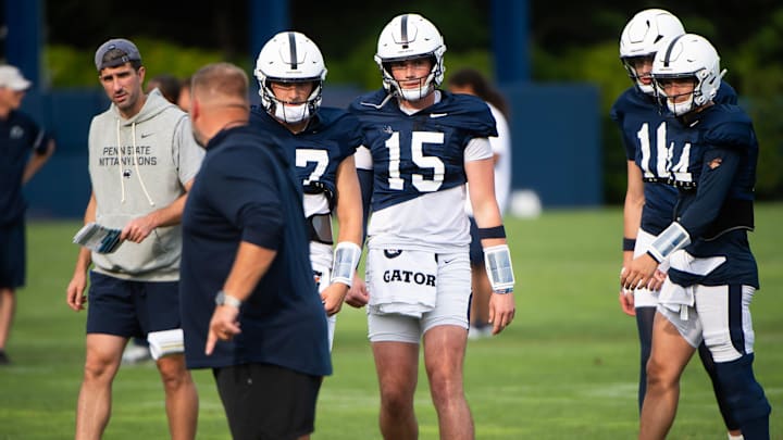 Penn State quarterbacks coach Danny O'Brien and offensive coordinator Andy Kotelnicki coach up quarterbacks Ethan Grunkemeyer, Drew Allar, Bekkem Kritza and Jaxon Smolik during practice outside Holuba Hall.