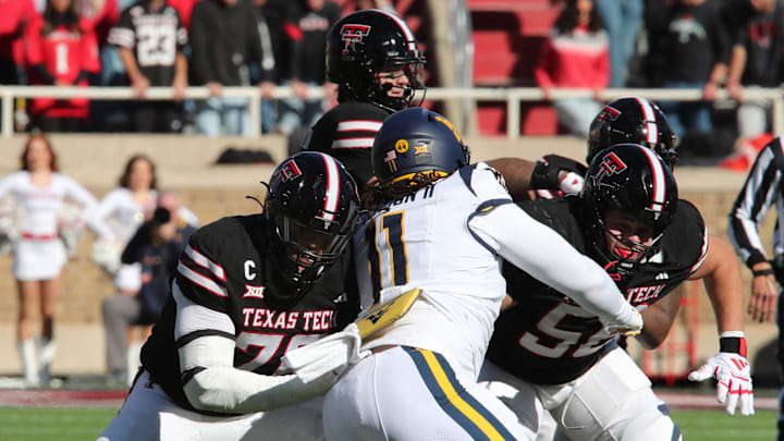 Nov 30, 2024; Lubbock, Texas, USA; Texas Tech Red Raiders offensive lineman Caleb Rogers (76) blocks West Virginia Mountaineers defensive tackle T.J. Jackson II (11) in the first half at Jones AT&T Stadium and Cody Campbell Field. Mandatory Credit: Michael C. Johnson-Imagn Images Nov 30, 2024; Lubbock, Texas, USA; Texas Tech Red Raiders offensive lineman Caleb Rogers (76) blocks West Virginia Mountaineers defensive tackle T.J. Jackson II (11) in the first half at Jones AT&T Stadium and Cody Campbell Field. Mandatory Credit: Michael C. Johnson-Imagn Images
