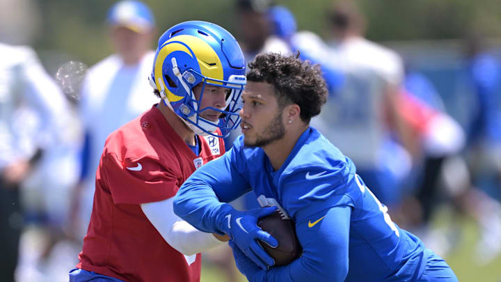 May 28, 2024; Thousand Oaks, CA, USA; Los Angeles Rams quarterback Matthew Stafford (9) hands off to running back Blake Corum (22) during OTAs at California Lutheran University. Mandatory Credit: Jayne Kamin-Oncea-USA TODAY Sports May 28, 2024; Thousand Oaks, CA, USA; Los Angeles Rams quarterback Matthew Stafford (9) hands off to running back Blake Corum (22) during OTAs at California Lutheran University. Mandatory Credit: Jayne Kamin-Oncea-USA TODAY Sports