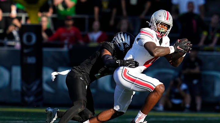 Oct 12, 2024; Eugene, Oregon, USA; Ohio State Buckeyes wide receiver Jeremiah Smith (4) catches a pass and is tackled by Oregon Ducks defensive back Brandon Johnson (3) during the first half of the NCAA football game at Autzen Stadium