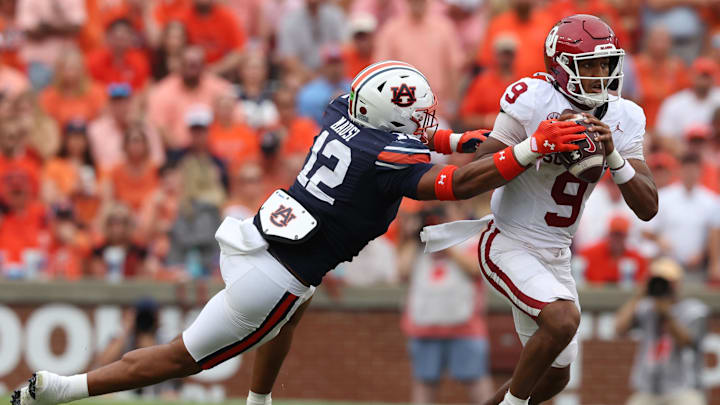 Sep 28, 2024; Auburn, Alabama, USA; Auburn Tigers linebacker Dorian Mausi Jr. (12) moves in to tackle Oklahoma Sooners quarterback Michael Hawkins Jr. (9) during the second quarter at Jordan-Hare Stadium. Mandatory Credit: John Reed-Imagn Images