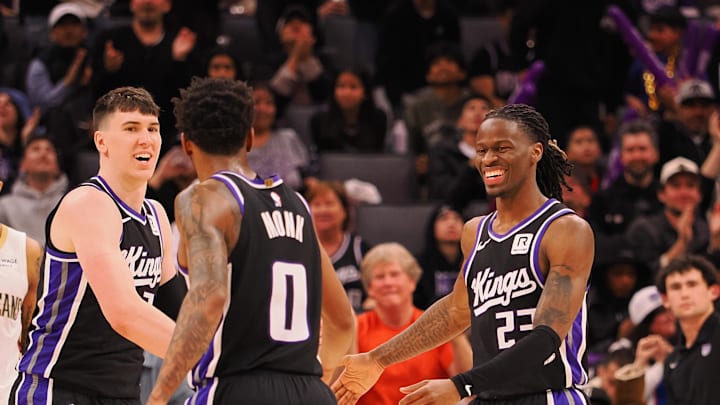 Feb 8, 2025; Sacramento, California, USA; Sacramento Kings forward Jake LaRavia (33), guard Malik Monk (0) and guard Keon Ellis (23) celebrate after a play against the New Orleans Pelicans during the fourth quarter at Golden 1 Center. Mandatory Credit: Kelley L Cox-Imagn Images