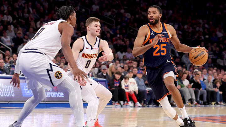 New York Knicks forward Mikal Bridges drives to the basket against Denver Nuggets guard Christian Braun. Mandatory Credit: Brad Penner-Imagn Images New York Knicks forward Mikal Bridges drives to the basket against Denver Nuggets guard Christian Braun. Mandatory Credit: Brad Penner-Imagn Images