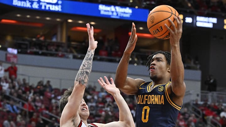Mar 5, 2025; Louisville, Kentucky, USA;  California Golden Bears guard Jeremiah Wilkinson (0) shoots against Louisville Cardinals guard Reyne Smith (6) during the first half at KFC Yum! Center. Mandatory Credit: Jamie Rhodes-Imagn Images
