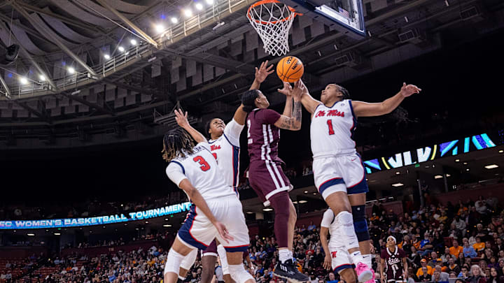 Mar 6, 2025; Greenville, SC, USA; Ole Miss Rebels guard KK Deans (1) blocks a shot from Mississippi State Bulldogs guard Jerkaila Jordan (2) during the first half at Bon Secours Wellness Arena. Mandatory Credit: Scott Kinser-Imagn Images