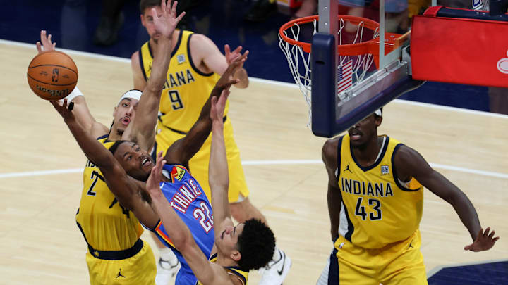 Jun 19, 2025; Indianapolis, Indiana, USA; Oklahoma City Thunder guard Cason Wallace (22) shoots the ball defended by Indiana Pacers guard Andrew Nembhard (2) and guard Ben Sheppard (26) in the fourth quarter during game six of the 2025 NBA Finals at Gainbridge Fieldhouse. Mandatory Credit: Trevor Ruszkowski-Imagn Images