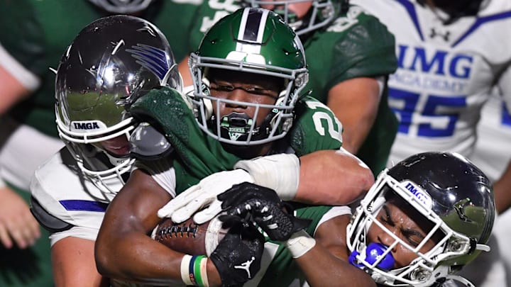 Venice High running back Dorian Irving-Jones (#21) is wrapped up by IMG Academy defenders. The Venice High School Indians hosted the IMG Academy Ascenders National team on Friday, Oct. 4, 2024. Venice High running back Dorian Irving-Jones (#21) is wrapped up by IMG Academy defenders. The Venice High School Indians hosted the IMG Academy Ascenders National team on Friday, Oct. 4, 2024.