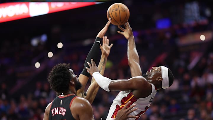 Feb 26, 2026; Philadelphia, Pennsylvania, USA; Miami Heat center Bam Adebayo (13) drives for a shot in front of Philadelphia 76ers center Joel Embiid (21) during the first quarter at Xfinity Mobile Arena. Mandatory Credit: Bill Streicher-Imagn Images
