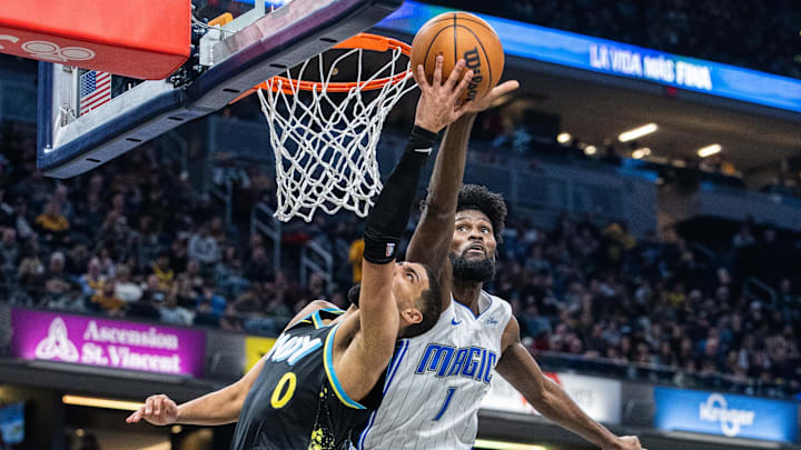 Indiana Pacers guard Tyrese Haliburton (0) shoots the ball while Orlando Magic forward Jonathan Isaac (1) defends in the first half at Gainbridge Fieldhouse.