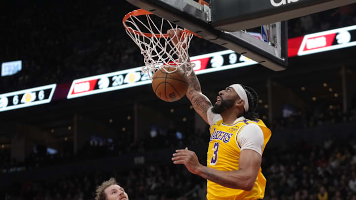 Nov 1, 2024; Toronto, Ontario, CAN; Los Angeles Lakers forward Anthony Davis (3) scores a basket as Toronto Raptors center Jakob Poeltl (19) looks on during the first half at Scotiabank Arena. Mandatory Credit: John E. Sokolowski-Imagn Images