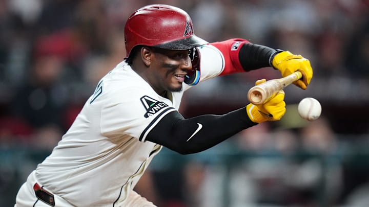 Apr 8, 2025; Phoenix, Ariz., U.S.; Arizona Diamondbacks Geraldo Perdomo attempts to lay down a bunt against the Baltimore Orioles at Chase Field.