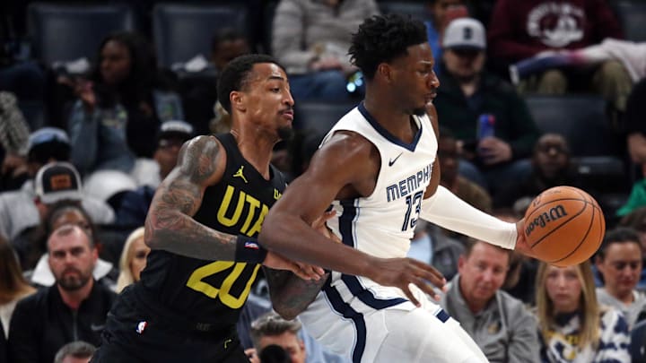 Nov 29, 2023; Memphis, Tennessee, USA; Memphis Grizzlies forward-center Jaren Jackson Jr. (13) spins toward the basket as Utah Jazz forward John Collins (20) defends during the second half at FedExForum. Mandatory Credit: Petre Thomas-Imagn Images