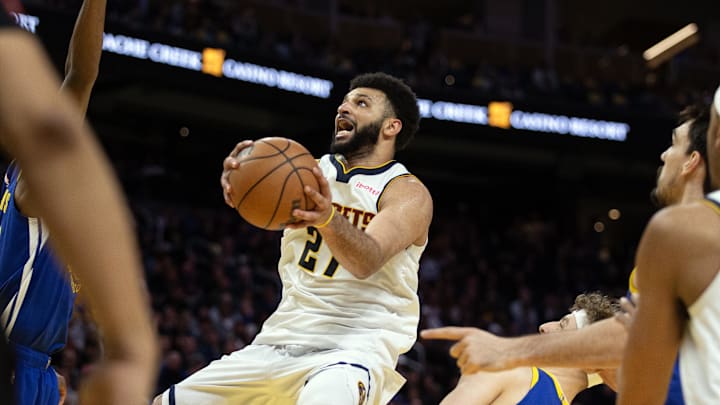 Feb 25, 2024; San Francisco, California, USA; Denver Nuggets guard Jamal Murray (27) goes up for a shot between a trio of Golden State Warriors defenders during the fourth quarter at Chase Center. Mandatory Credit: D. Ross Cameron-Imagn Images