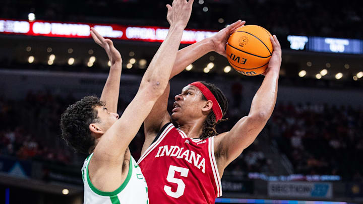 Mar 13, 2025; Indianapolis, IN, USA; Indiana Hoosiers forward Malik Reneau (5) shoots the ball while Oregon Ducks forward Brandon Angel (21) defends in the first half at Gainbridge Fieldhouse. Mandatory Credit: Trevor Ruszkowski-Imagn Images