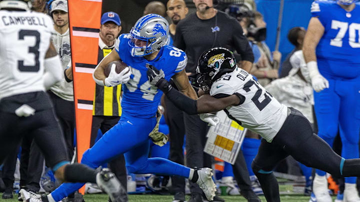 Nov 17, 2024; Detroit, Michigan, USA; Detroit Lions tight end Shane Zylstra (84) runs with the ball in front of Jacksonville Jaguars linebacker Foyesade Oluokun (23) during the first half at Ford Field. Mandatory Credit: David Reginek-Imagn Images