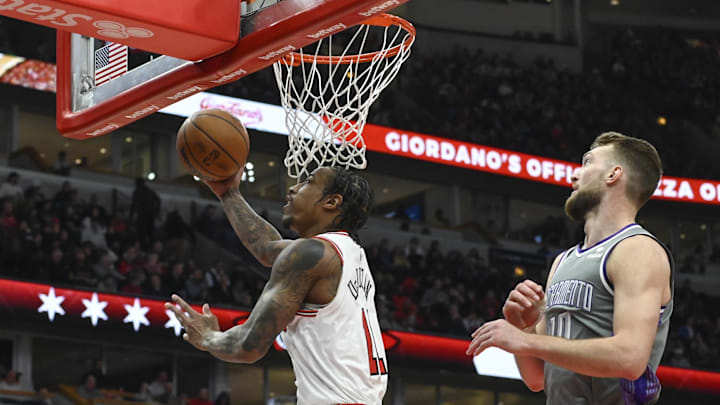 Mar 15, 2023; Chicago, Illinois, USA; Chicago Bulls forward DeMar DeRozan (11) scores past Sacramento Kings forward Domantas Sabonis (10) during the first half at the United Center. Mandatory Credit: Matt Marton-Imagn Images
