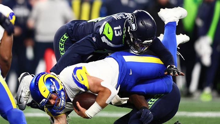Jan 25, 2026; Seattle, WA, USA; Los Angeles Rams quarterback Matthew Stafford (9) dives for a first down against Seattle Seahawks linebacker Ernest Jones IV (13) during the second half in the 2026 NFC Championship Game at Lumen Field. Mandatory Credit: Kevin Ng-Imagn Images
