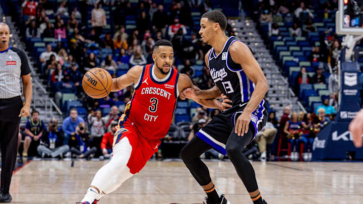 Feb 13, 2025; New Orleans, Louisiana, USA;  New Orleans Pelicans guard CJ McCollum (3) dribbles against Sacramento Kings forward Keegan Murray (13) during the second half at Smoothie King Center. Mandatory Credit: Stephen Lew-Imagn Images