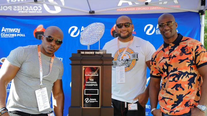 Sep 22, 2018; Knoxville, TN, USA; Travis Stephens and Darwin Walker and Deon Grant, members of the 1998 Tennessee Volunteers national championship team, pose with the Amway Coaches Trophy before the game between the Florida Gators and Tennessee Volunteers in Knoxville, TN. Mandatory Credit: Randy Sartin-Imagn Images