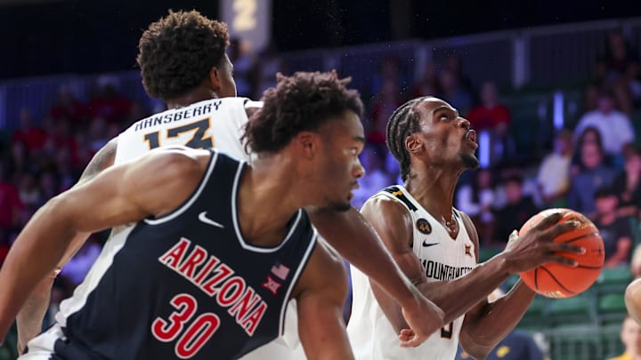 Nov 29, 2024; Paradise Island, Bahamas, BHS; West Virginia Mountaineers guard Toby Okani (5) shoots past Arizona Wildcats forward Tobe Awaka (30) during the second half at Imperial Arena at the Atlantis resort. Mandatory Credit: Kevin Jairaj-Imagn Images Nov 29, 2024; Paradise Island, Bahamas, BHS; West Virginia Mountaineers guard Toby Okani (5) shoots past Arizona Wildcats forward Tobe Awaka (30) during the second half at Imperial Arena at the Atlantis resort. Mandatory Credit: Kevin Jairaj-Imagn Images