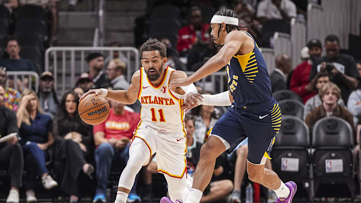 Oct 8, 2024; Atlanta, Georgia, USA; Atlanta Hawks guard Trae Young (11) is defended by Indiana Pacers guard Andrew Nembhard (2) during the first half at State Farm Arena. Mandatory Credit: Dale Zanine-Imagn Images