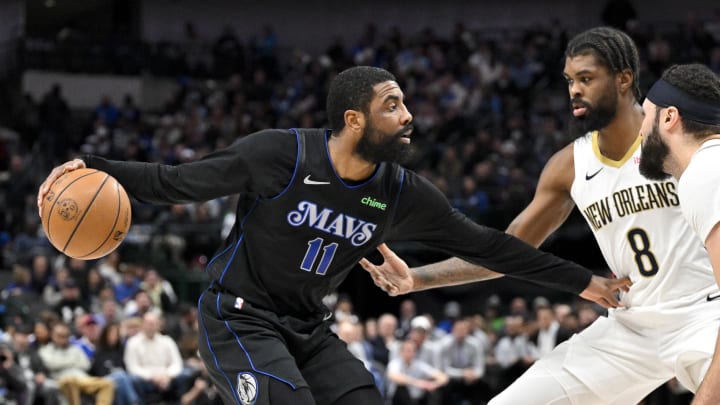 Jan 15, 2024; Dallas, Texas, USA; Dallas Mavericks guard Kyrie Irving (11) looks to move the ball past New Orleans Pelicans forward Naji Marshall (8) during the second quarter at the American Airlines Center. Mandatory Credit: Jerome Miron-USA TODAY Sports