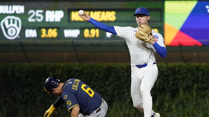 Aug 20, 2025; Chicago, Illinois, USA; Chicago Cubs second base Nico Hoerner (2) forces out Milwaukee Brewers outfielder Isaac Collins (6) at second base then throws to first base to complete a double play during the sixth inning at Wrigley Field. Mandatory Credit: David Banks-Imagn Images