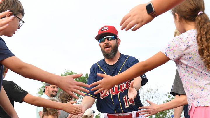The Greenville Drive took on the Bowling Green Hot Rods at Fluor Field on April 4, 2025.This was the opening day of the season and the 20h Anniversary of the Drive at the park. Greenville Drive's manager Liam Carroll (14) greets fans as he comes to the field.