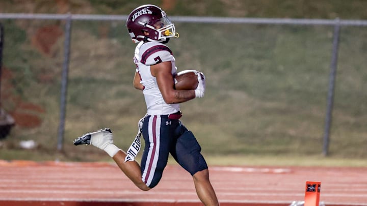 Jenks’ Kaydin Jones (2) runs the ball for a touchdown during a high school football game between Mustang and Jenks in Mustang, Okla., on Friday, Oct. 11, 2024.