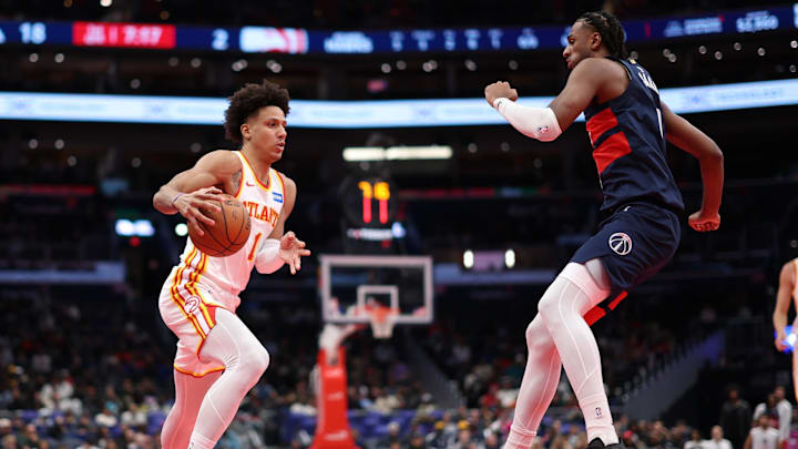 Nov 25, 2025; Washington, District of Columbia, USA; Atlanta Hawks forward Jalen Johnson (1) drives to the basket as Washington Wizards center Alex Sarr (20) defends in the first half at Capital One Arena. Mandatory Credit: Geoff Burke-Imagn Images