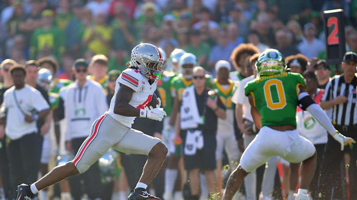 Jan 1, 2025; Pasadena, CA, USA; Ohio State Buckeyes wide receiver Jeremiah Smith (4) runs to score a touchdown in the first quarter against the Oregon Ducks in the 2025 Rose Bowl college football quarterfinal game at Rose Bowl Stadium. Mandatory Credit: Gary A. Vasquez-Imagn Images