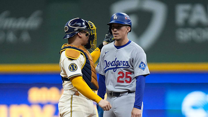 Milwaukee Brewers catcher William Contreras (24) talks with Los Angeles Dodgers second baseman Tommy Edman (25) after Los Angeles Dodgers third baseman Max Muncy (13) hits into a force out to deep center field during the fourth inning of the of their National League Championship Series game October 13, 2025 at American Family Field in Milwaukee, Wisconsin. Milwaukee Brewers catcher William Contreras (24) talks with Los Angeles Dodgers second baseman Tommy Edman (25) after Los Angeles Dodgers third baseman Max Muncy (13) hits into a force out to deep center field during the fourth inning of the of their National League Championship Series game October 13, 2025 at American Family Field in Milwaukee, Wisconsin.