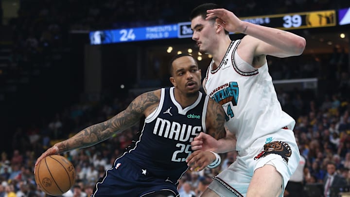 Dallas Mavericks forward P.J. Washington drives against Memphis Grizzlies center Zach Edey. Dallas Mavericks forward P.J. Washington drives against Memphis Grizzlies center Zach Edey.