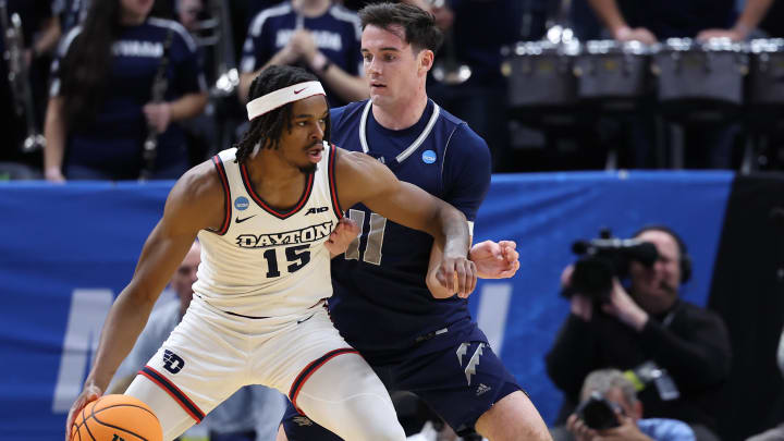 Mar 21, 2024; Salt Lake City, UT, USA; Dayton Flyers forward Daron Holmes II (15) dribbles against Nevada Wolf Pack forward Nick Davidson (11) during the first half in the first round of the 2024 NCAA Tournament at Vivint Smart Home Arena-Delta Center. Mandatory Credit: Rob Gray-USA TODAY Sports