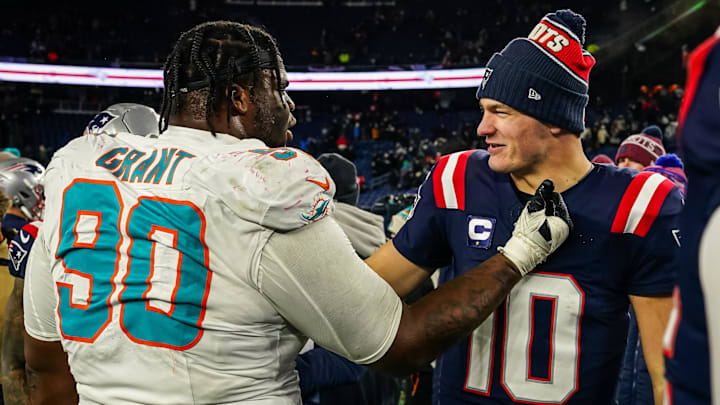 Jan 4, 2026; Foxborough, Massachusetts, USA; Miami Dolphins defensive tackle Kenneth Grant (90) greets New England Patriots quarterback Drake Maye (10) on the field after the game at Gillette Stadium. Mandatory Credit: David Butler II-Imagn Images