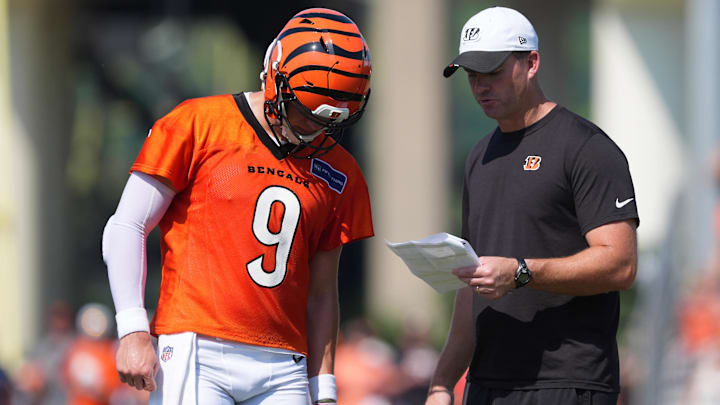 Jul 25, 2025; Cincinnati, OH, USA; Cincinnati Bengals quarterback Joe Burrow (9), left, talks with head coach Zac Taylor, right, during training camp practice. Mandatory Credit: Kareem Elgazzar-Imagn Images