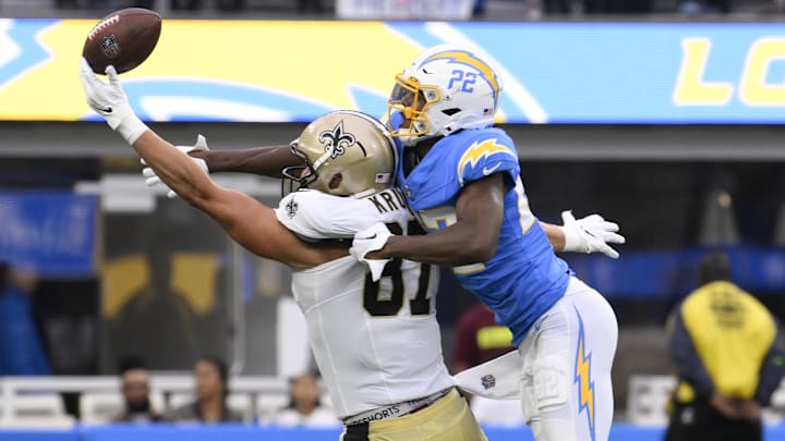 Aug 20, 2023; Inglewood, California, USA; Los Angeles Chargers safety JT Woods (22) tries to breakup a pass to New Orleans Saints tight end Lucas Krull (87) in the second quarter at SoFi Stadium. Mandatory Credit: Robert Hanashiro-Imagn Images