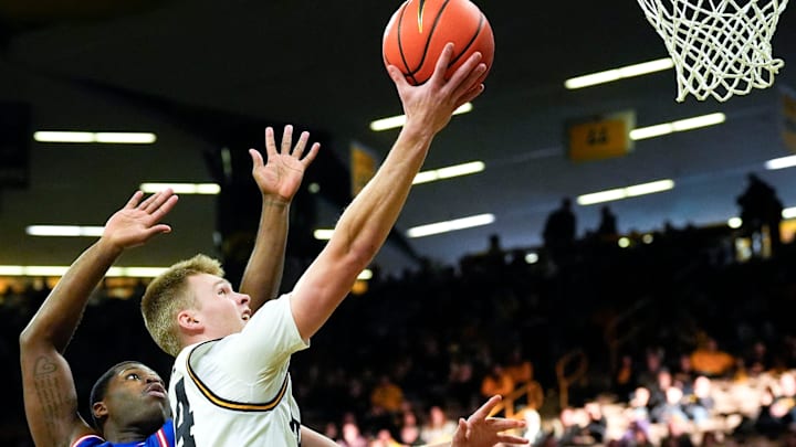 Iowa guard Bennett Stirtz (14) drives to the basket against UMass Lowell guard Xavier Spencer (11) Dec. 29, 2025 at Carver-Hawkeye Arena in Iowa City, Iowa. Iowa guard Bennett Stirtz (14) drives to the basket against UMass Lowell guard Xavier Spencer (11) Dec. 29, 2025 at Carver-Hawkeye Arena in Iowa City, Iowa.