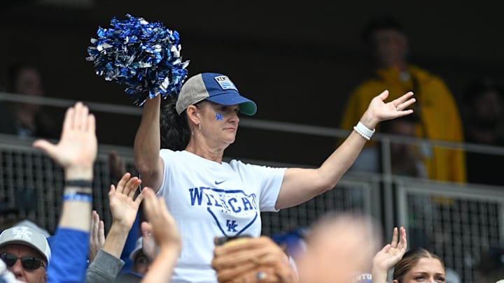 Jun 19, 2024; Omaha, NE, USA;  A fan for the Kentucky Wildcats cheers action against the Florida Gators during the fourth inning at Charles Schwab Field Omaha. Mandatory Credit: Steven Branscombe-Imagn Images
