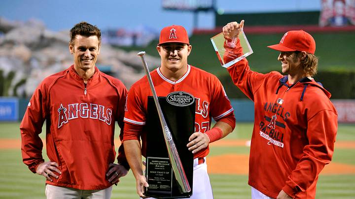 Anaheim, CA, USA; Los Angeles Angels center fielder Mike Trout (27) receives his silver slugger award from general manager Jerry DiPoto and starting pitcher C.J. Wilson before the game against the Texas Rangers at Angel Stadium of Anaheim. Mandatory Credit: Gary A. Vasquez-USA TODAY Sports
