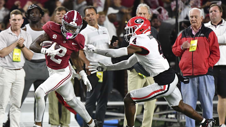 Sep 28, 2024; Tuscaloosa, Alabama, USA;  Alabama Crimson Tide wide receiver Ryan Williams (2) breaks a tackle by Georgia Bulldogs defensive back KJ Bolden (4) to score a touchdown that put Alabama ahead in the fourth quarter at Bryant-Denny Stadium. Alabama defeated Georgia 41-34. Mandatory Credit: Gary Cosby Jr.-Imagn Images